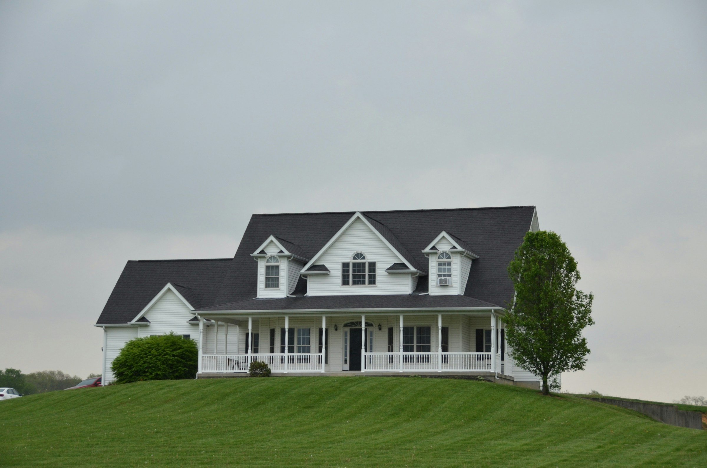Traditional home with a dark shingle roof